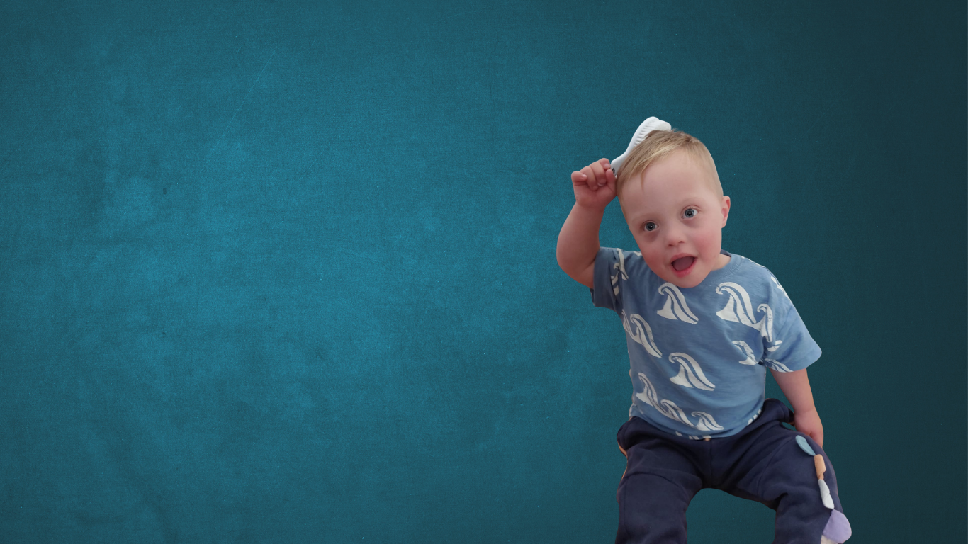 Child with down syndrome is brushing his hair