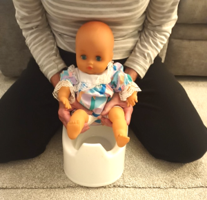 doll on the potty - toilet training representation image