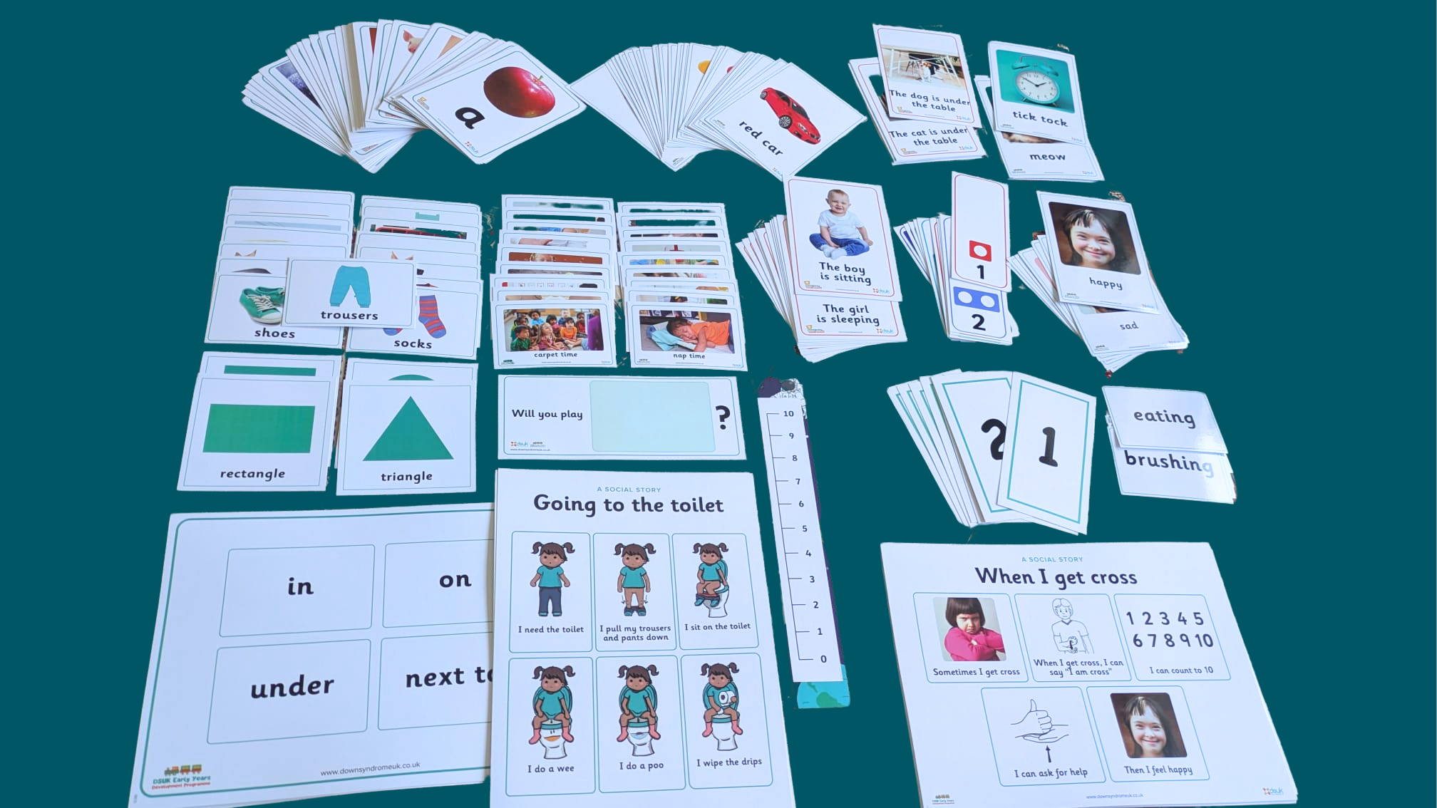 Early years development pack for professionals product shot with all the resources laid out on a block coloured background