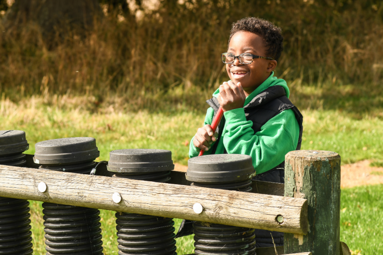 Little boy with Down syndrome playing outside